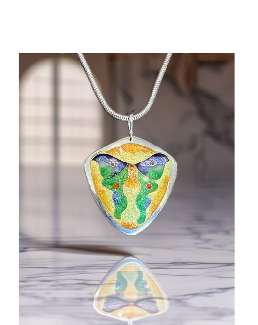 Colorful butterfly-shaped pendant on a chain against a blurred background
