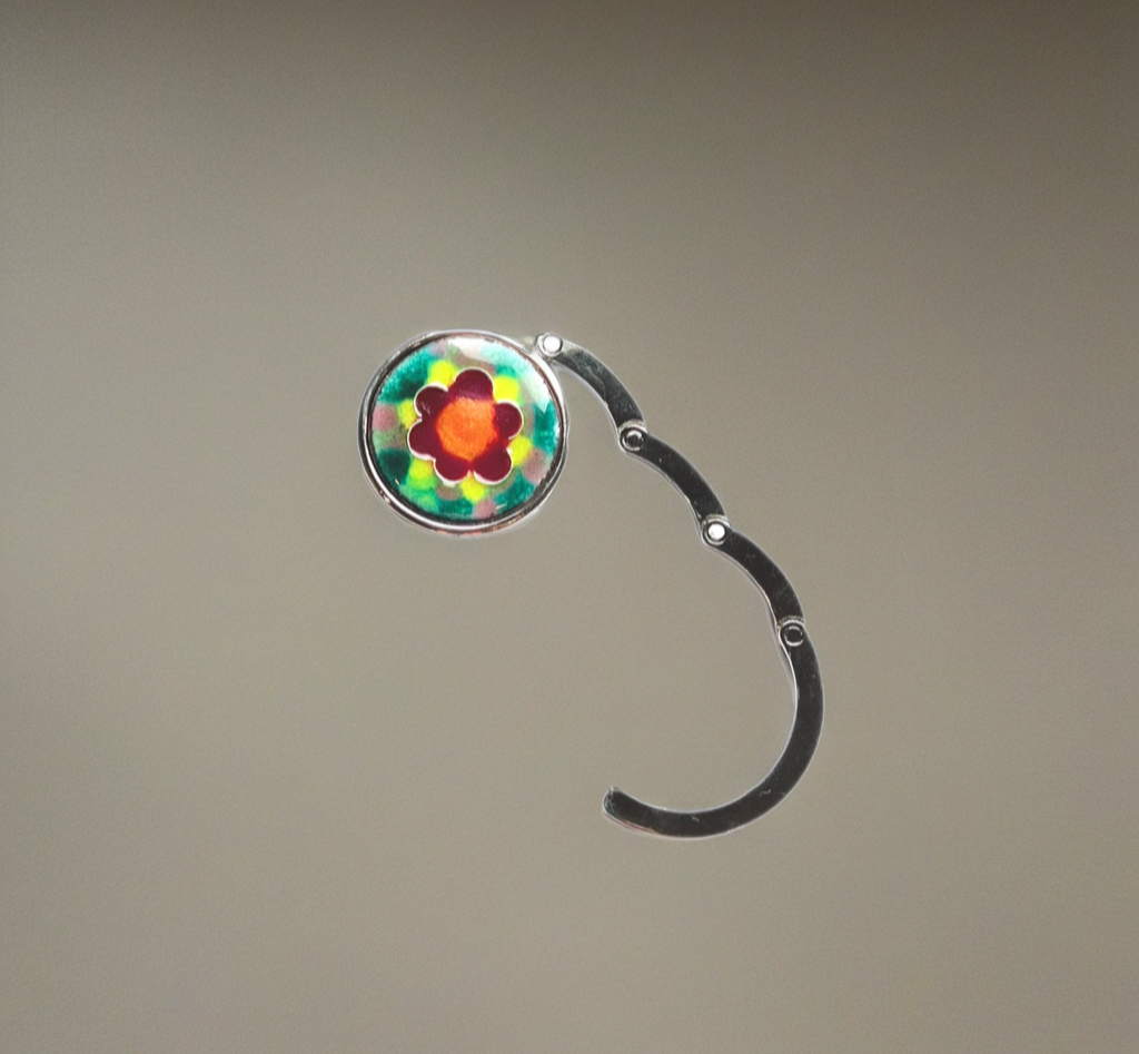 Flower-shaped purse hanger on a gray background