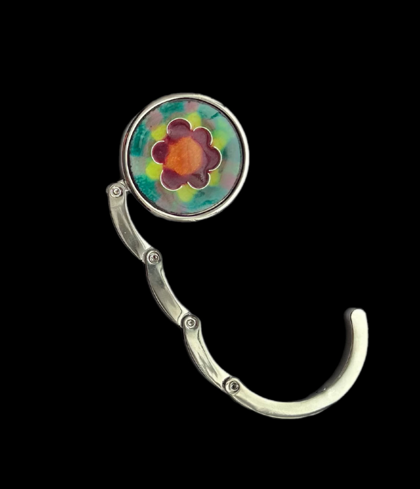 Folding handbag hook with a colorful flower design on a black background