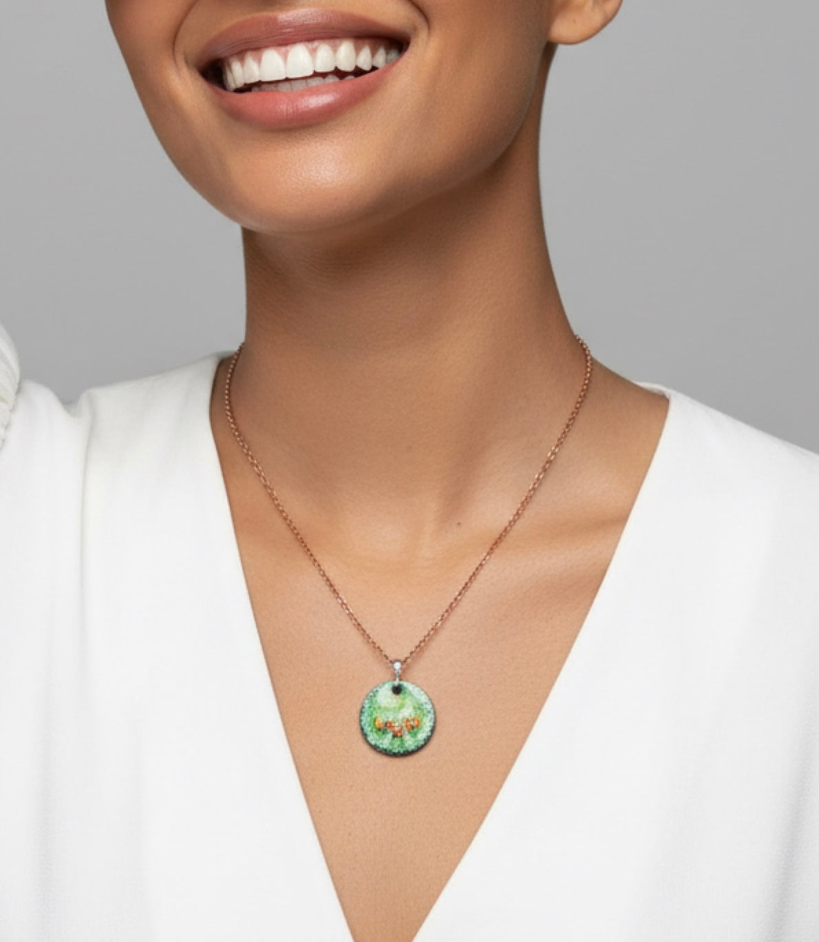 Necklace with a green pendant worn by a model against a neutral background