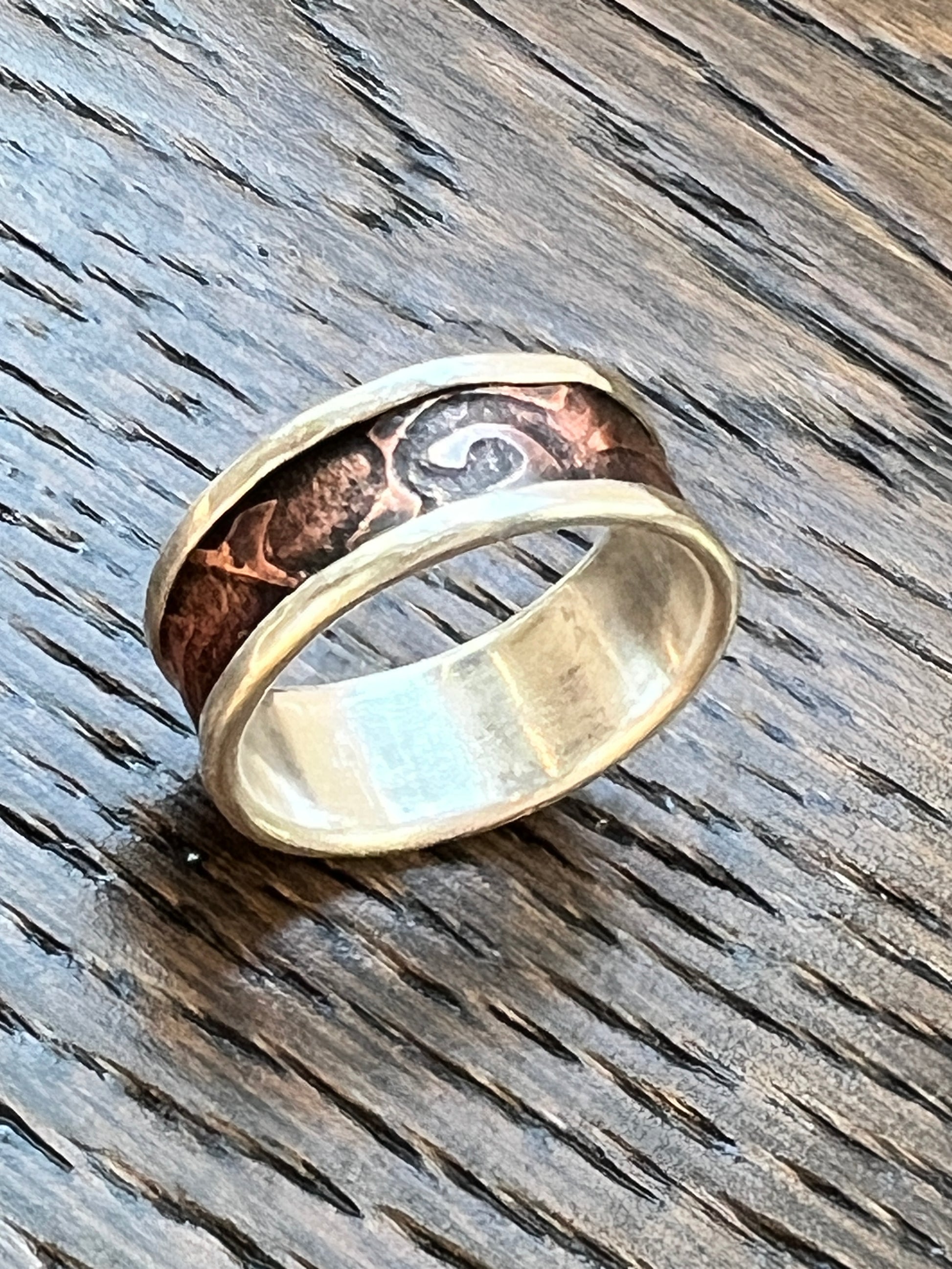 Two metals ring on a wooden surface