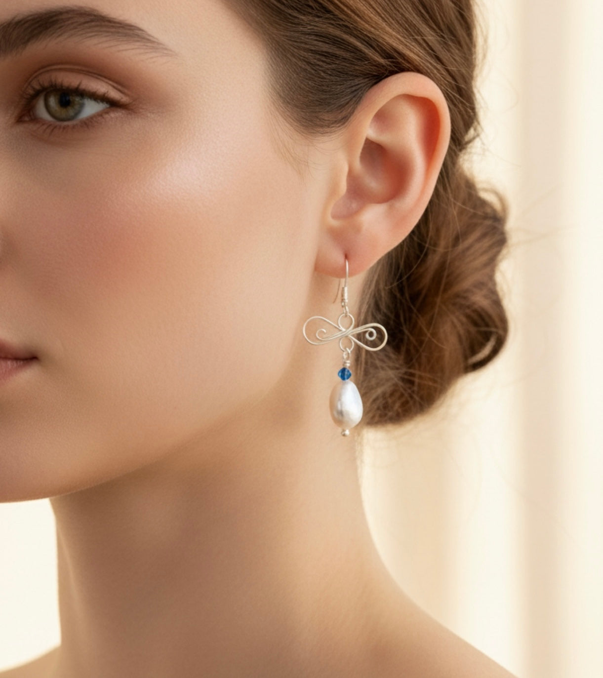 woman posing with silver and pearl earrings