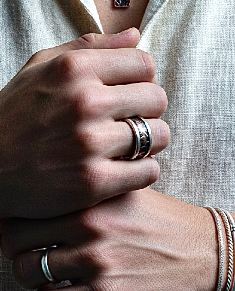 Close-up of hands with rings on a neutral background