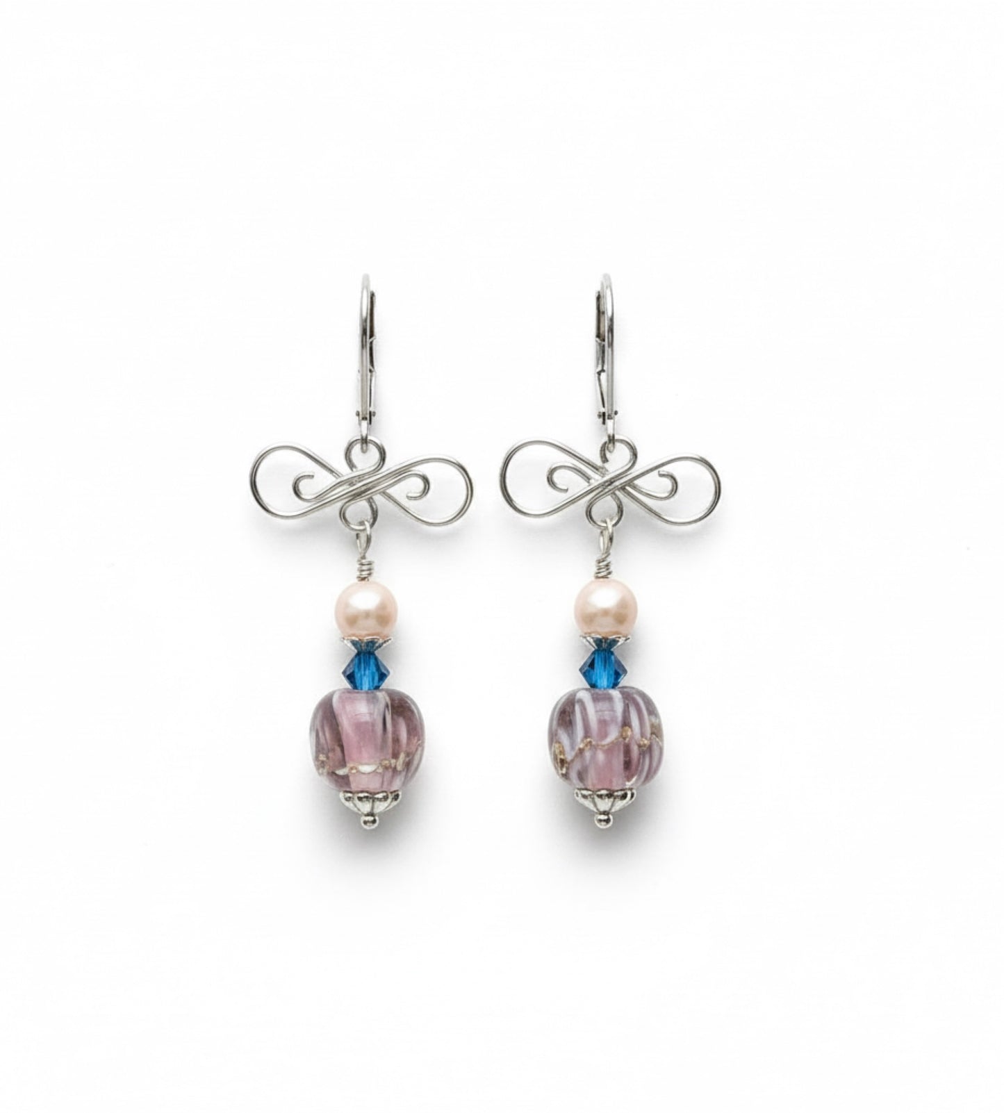 Pair of earrings with purple beads and blue accents on a white background