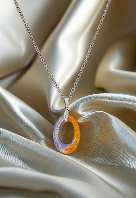 Necklace with a colorful pendant on a beige fabric background