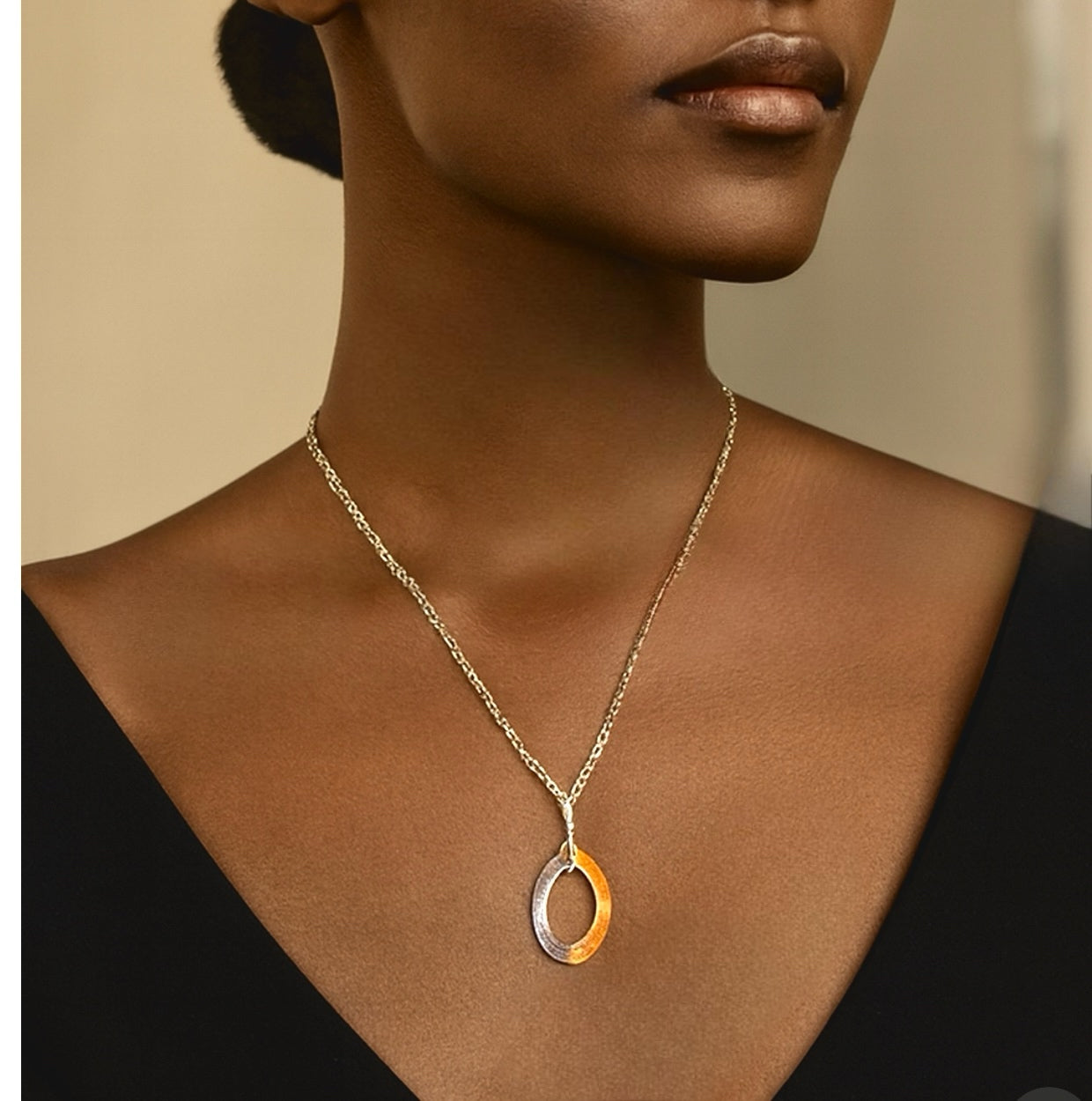 Necklace with a pendant on a model against a neutral background
