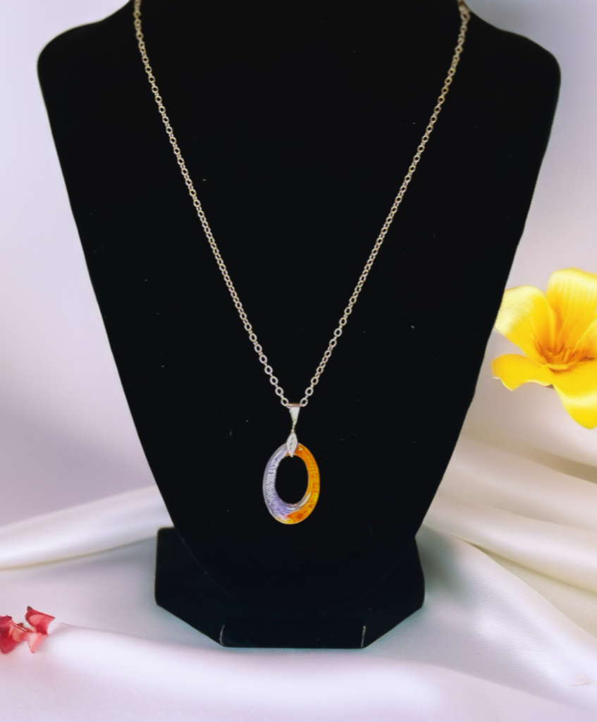 Necklace with a pendant on a black stand with a yellow flower in the background