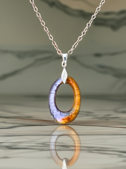 Necklace with a unique pendant on a reflective surface