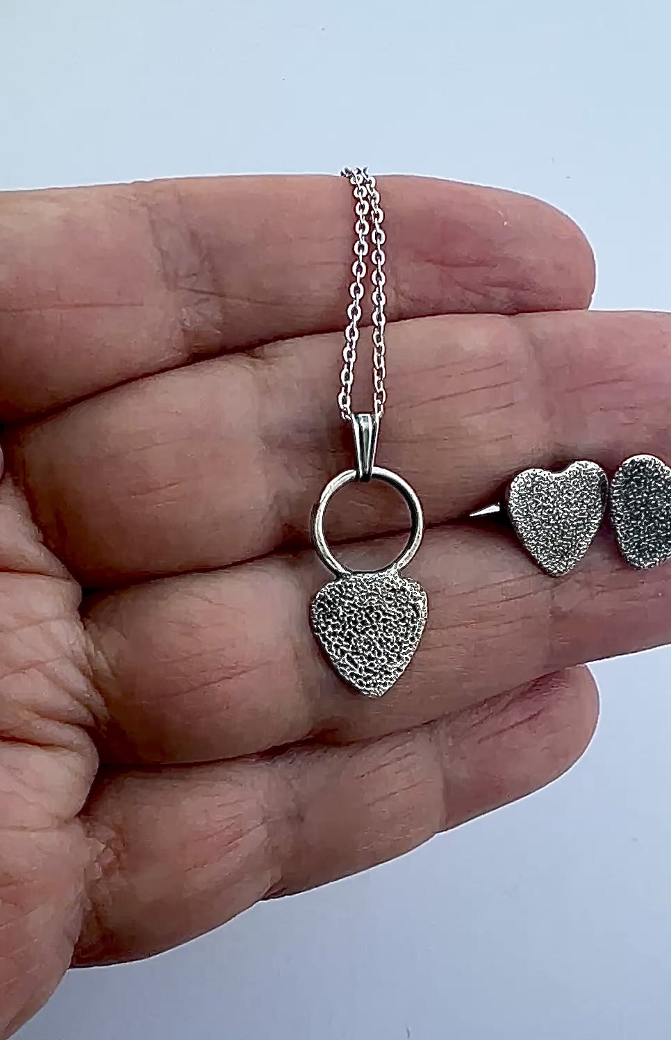 hand holding jewelry set and moving