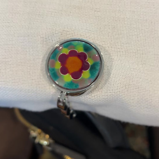 video of purse hanger holding a backpack at a table