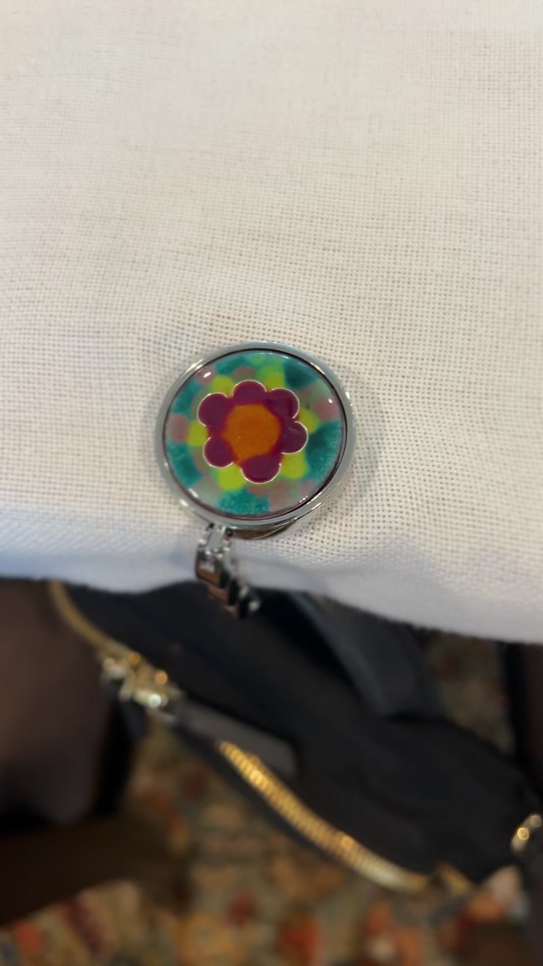 video of purse hanger holding a backpack at a table